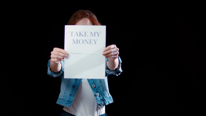 (Camera: ARRI ALEXA, 35mm lens, real time) A young caucasian woman points to a paper saying "Take my money". For more variations of this clip, check out this seller's other videos.