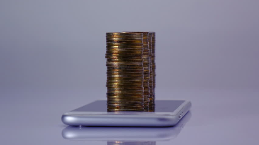 Coins stack increase on smart phone with business data hologram. business growth concept.	 | Shutterstock HD Video #1099932831