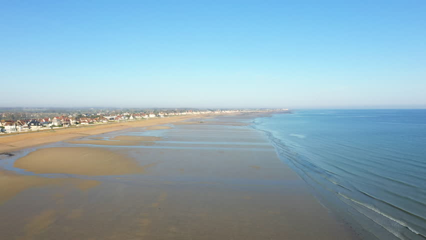 The immense beach of Sword beach and the Channel Sea in Europe, in France, in Normandy, towards Caen, in Lion sur Mer, in spring, on a sunny day.