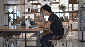 Asian freelancer co work cafe. Busy person use computer macbook coworking place. Boss man drink coffee cup. People study code web app. Male user write start up laptop desk. Coworker guy job sit home. - Powered by Shutterstock - Get 15% off with code: PIKWIZARD15