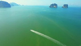 Drone is flying over Boat cruising along the river at the bay in the tropics. Krabi, Thailand. nature background video. tropical paradise. Travel destination concept. Stunning stock video footage
