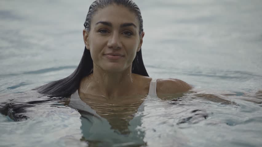 Slow motion close up portrait of smiling woman swimming, cedar hills, utah, united states | Shutterstock HD Video #1099940991