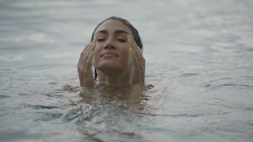 Slow motion close up of woman relaxing in swimming pool, cedar hills, utah, united states | Shutterstock HD Video #1099941025