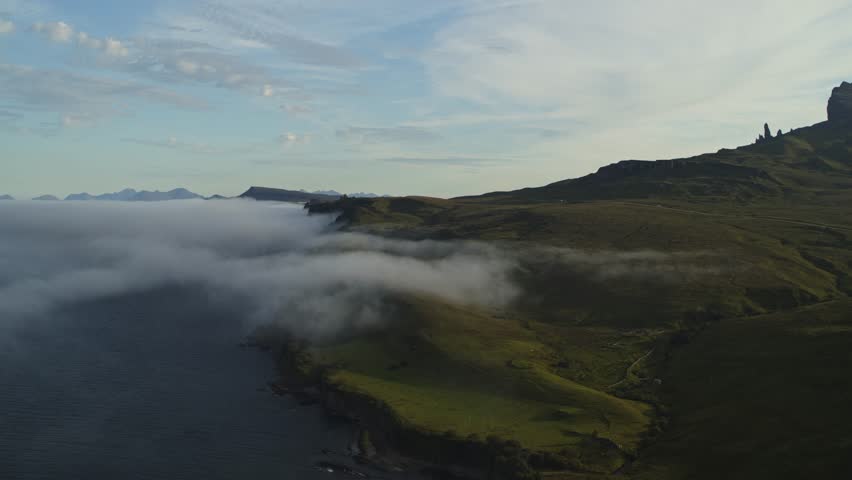 Scenic aerial flyover view of isle of skye shoreline, portree, scotland