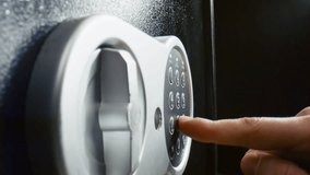 Man hand closing metal strongbox door close up. Unknown person entering numbers combination on electronic panel to lock modern safe. Male fingers pressing locker buttons using correct pass code. - Powered by Shutterstock - Get 15% off with code: PIKWIZARD15