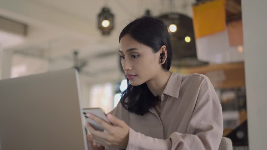 Asian freelancer cell cafe. Busy person use computer macbook coworking place. Boss woman look screen monitor. People study iphon network. Female user start up laptop desk. Coworker girl job home space