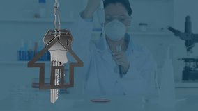 Animation of silver key with house key fob over female scientist in laboratory. Global science, hosuing and data processing concept digitally generated video.