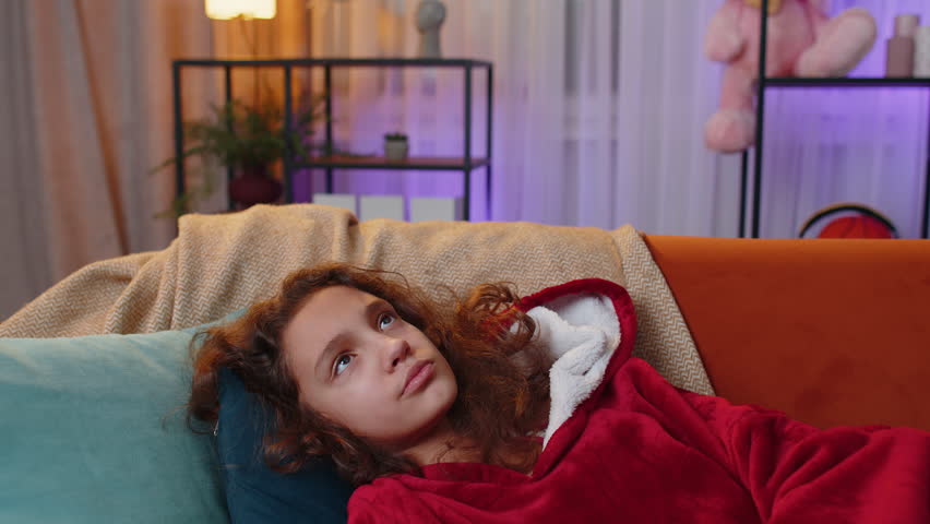 Sad lonely preteen girl at home looks pensive thinks over life concerns or unrequited love, suffers from unfair situation. Young child, kid problem, break up, depressed feeling bad annoyed burnout