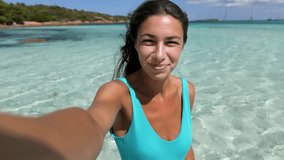 Point of View: Portrait of a Beautiful Woman in a Swimming Suit Having a Video Call Using a Smartphone. Female Adult Calling Family During Summer Retreat Vacation on the Beach. Screen Replacement