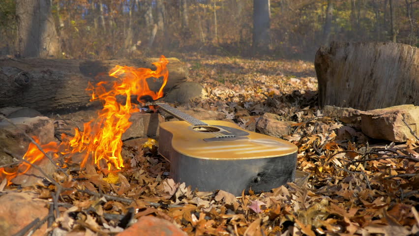 Lockdown Shot Of Orange Colored Flame Around Guitar In Dry Forest - Madison, Wisconsin