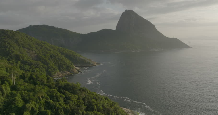 Aerial Shot Of Sugarloaf Mountain Under Cloudy Sky, Drone Flying Forward Over Sea - Rio de Janeiro, Brazil