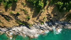 Aerial view Drone camera top down of seashore rocks in ocean, Beautiful sea surface Amazing sea waves crashing on rocks seascape in Phuket island Thailand Aerial view drone 4k High quality footage