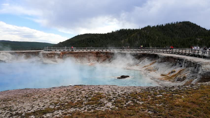 Beautiful view of hot spring pool geothermal landscape. Geyser basin and forest. Famous tourist attraction at Yellowstone national park. Hot thermal spring Black Pool in Yellowstone National Park