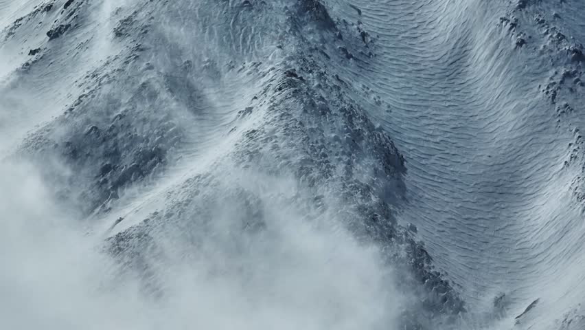 Aerial shot with drone of Etna in winter. Snow-covered craters, Etna in activity, Valle del Bove and summit craters. Snowy woods. South-East, North-East, Voragine, Bocca Nuova. 
