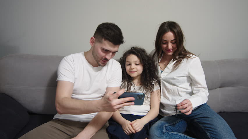 A young family makes an online video call, talking and showing a house key in a new apartment. Modern communication and moving concept | Shutterstock HD Video #1099960959