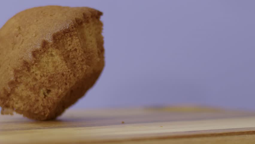 Sweet, cupcake cookies on a wooden board on a grey background. Slow motion, 4K. | Shutterstock HD Video #1099965189