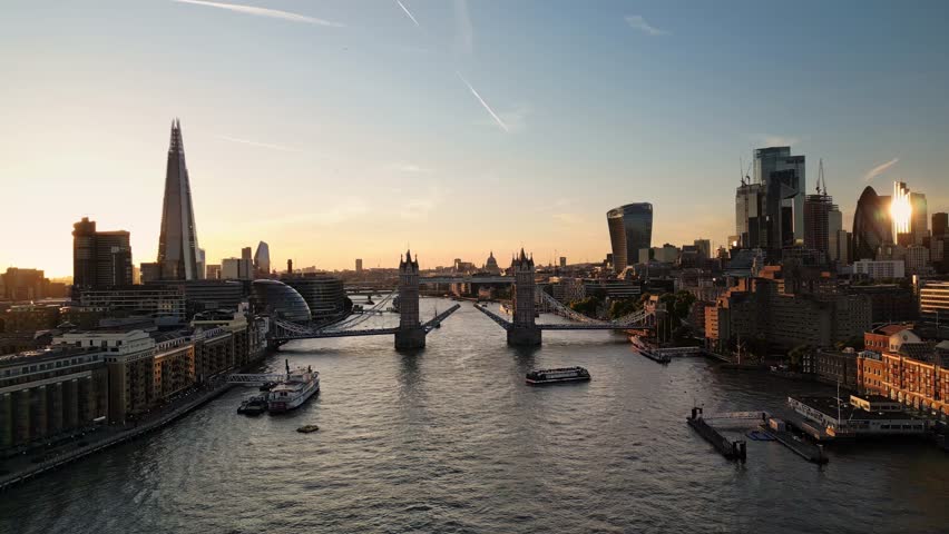 Establishing Aerial Drone Helicopter View Of Tower Bridge Lifted And Boat Passing London City Skyline The Shard And Thames River London Skyscraper UK, United Kingdom At Sunset Royalty-Free Stock Footage #1099965943