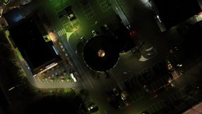 Aerial drone video takes you on a night-time journey through a drive-through restaurant, with top-down views of cars and customers.