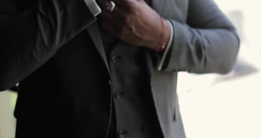 handsome male hands fixing tie and jacket. the businessman defiantly adjusts his clothes. close-up of a man's hands in a tuxedo Royalty-Free Stock Footage #1099968403