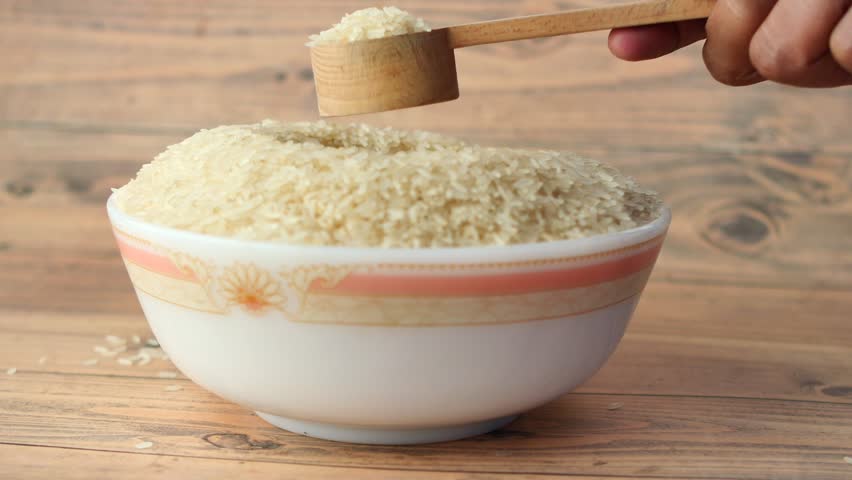 Spoon pick rice from a bowl on table  | Shutterstock HD Video #1099969309