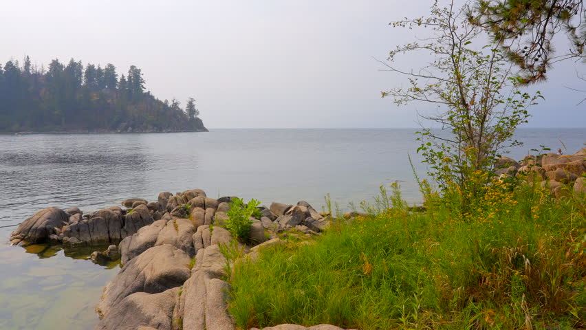 Establishing shot of lake with white clouds in Vancouver, Canada, North America. Day time on July 2022. Still camera view. ProRes 422 HQ.