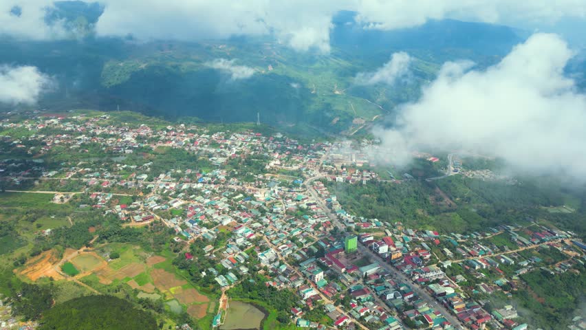 Small city in the high mountains with many brightly colored houses and flying clouds 1