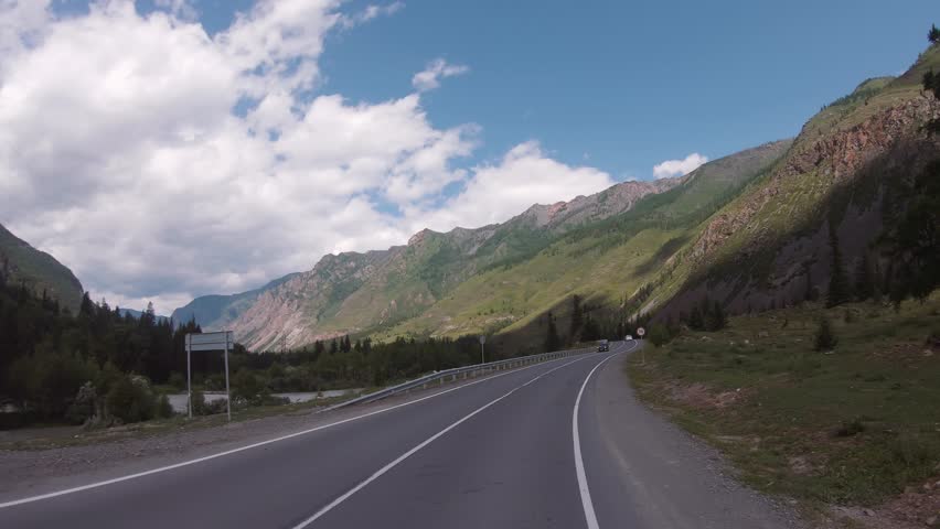 Driving in a car In summer season along the mountain road of the Chuya Highway or the Chuysky Trakt in Altai. Road between Chibit and White Bom. Siberia, Russia
