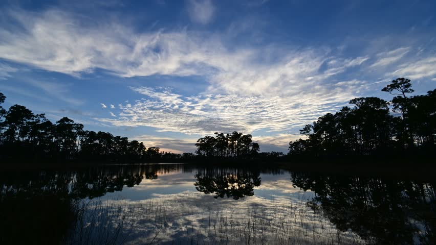 Time lapse of sunset cloudscape over Long Pine Key lake and campground in Everglades National Park, Florida 4K.
