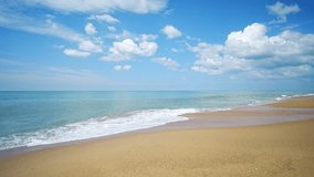 Seascape good clouds blue sky island sunny. Panorama Sea wave slow water splash shore golden sandy beach summer day. Travel tropical beach vacation relax seaside paradise. Video 4k copy space area.
