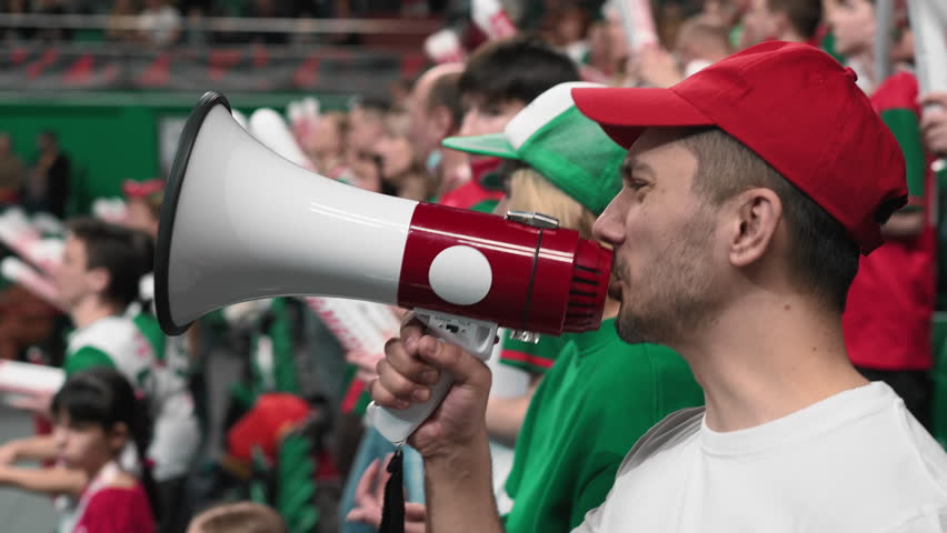 Crazy fan loss goal win bet. Angry mad man scream megaphone bullhorn. Aggressive evil guy fail sport game cup. Anger furious male shout loudspeaker close up. Wild loud megaphone yell. Bully view play Royalty-Free Stock Footage #1099980695