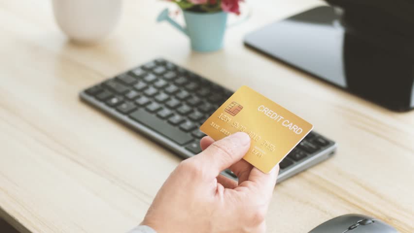 Male hands holding  gold credit card making e bank online payment. Man consumer paying for purchase in web store using laptop technology. Ecommerce website payments concept. Royalty-Free Stock Footage #1099981551