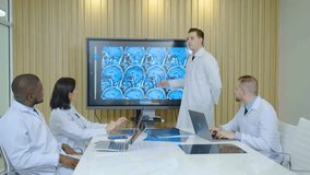 Male And Female Physician Presents Patient X-ray on TV Screen, Team of Medical Doctors Discuss Treatment, clapping hands after the end of effective meeting in modern medical office - Powered by Shutterstock - Get 15% off with code: PIKWIZARD15