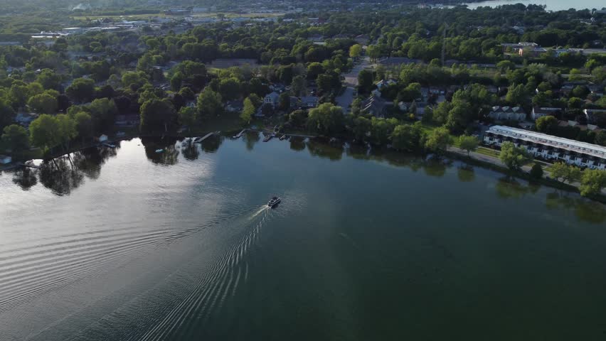 An aerial view of the waterfront area with a ship sailing nearby in Orillia, Ontario, Canada