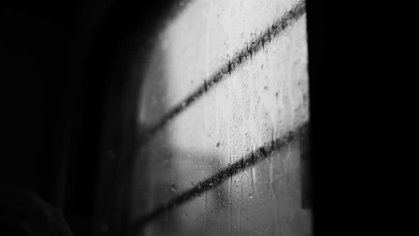 A grayscale view of a wet train window in the rainy weather Royalty-Free Stock Footage #1099996181