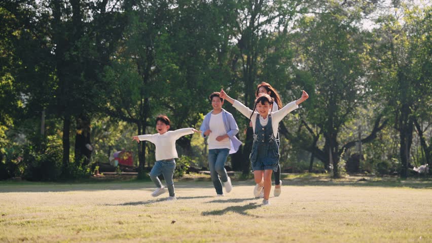 Asian family running together in nature park, Long weekend and holidays concept | Shutterstock HD Video #1100005549