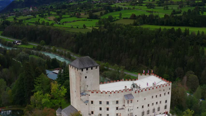 Aerial Flying Over Castle Bruck Beside River Isel In Austria With Countryside Landscape In Background 