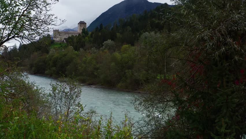 Aerial Ascending Through Trees Beside River Isel With View Of Castle Bruck In Austria