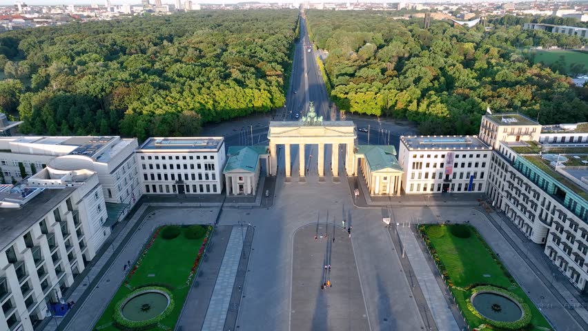 Aerial View of Brandenburg Gate (Brandenburger Tor) early morning at sunrise - monument in Berlin, Capital of Germany, Europe, with Skyline at the Background. 4K Shot of European City Landmark