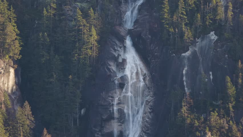 Shannon Falls in Squamish, BC, Canada. Canadian Nature Background. Sunny winter Sunset. Slow Motion Cinematic