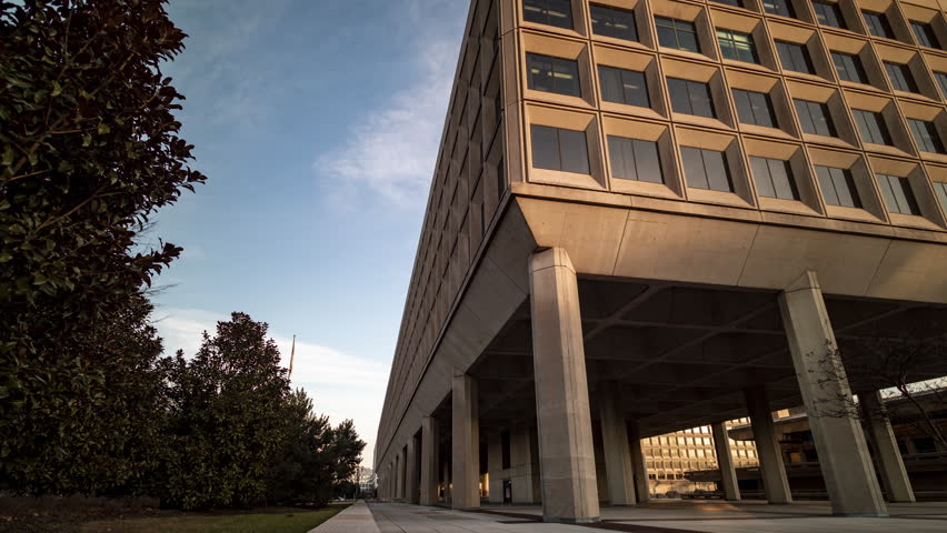 A motion timelapse captures the golden hour at the James V. Forrestal Building Building, the headquarters of the United States Department of Energy, in downtown Washington, DC at sunset.