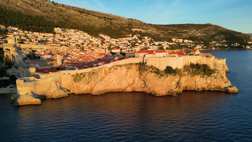 Aerial drone view of the Old historic city of Dubrovnik in Croatia, UNESCO World Heritage site. Famous tourist attraction in the Adriatic Sea. Fortified old city. Tourism and travel to Croatia.