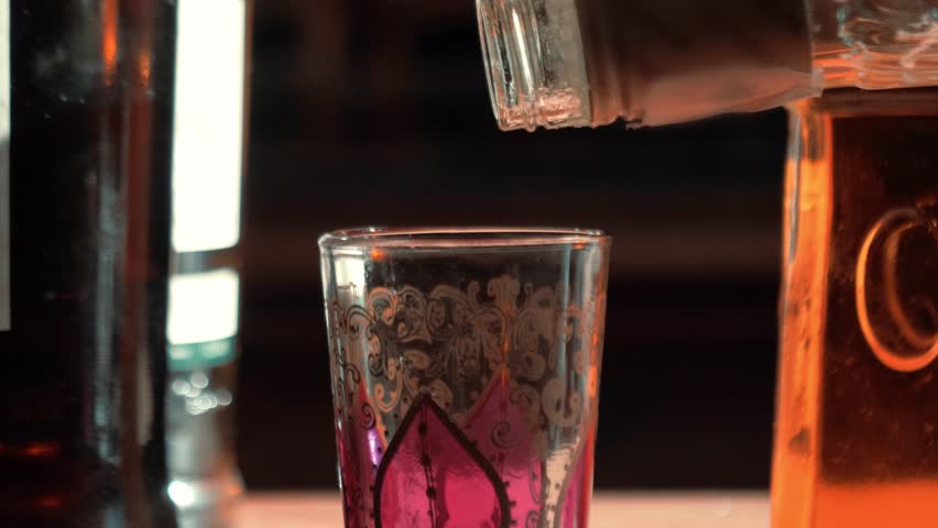 pouring liquor into a glass