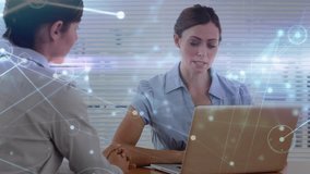 Animation of data processing over caucasian businesswomen using laptop. Global business, finances, computing and data processing concept digitally generated video.