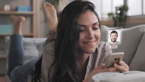 young woman using smartphone augmented reality dating app,female lying on couch uses smart phone browsing men profiles flirting on meeting site application searching for love - Powered by Shutterstock - Get 15% off with code: PIKWIZARD15