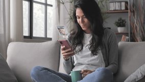 young woman using smartphone augmented reality dating app,brunette female sits on couch uses smart phone browsing men profiles flirting on social media application searching for love - Powered by Shutterstock - Get 15% off with code: PIKWIZARD15