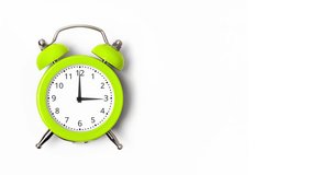 Animation of clock hands of lime green metal alarm clock isolated on white background. Concept of time. Alarm clock with moving arrows. 4k resolution video banner with copy space.