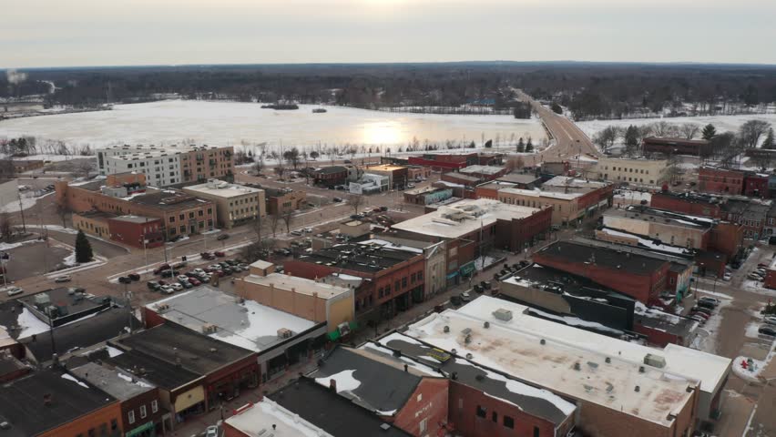 Aerial, empty downtown Stevens Point during winter season. Frozen Wisconsin River