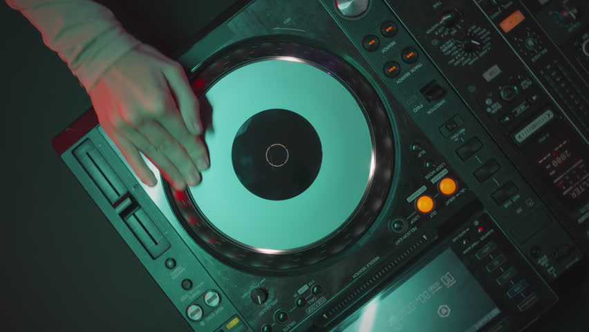 Top view of unrecognizable female dj spinning record on turntable while playing music at party in night club Royalty-Free Stock Footage #1100030965