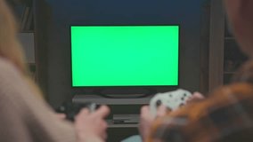 Couple of Gamers Playing Video Game with Console Controllers on Green Screen for Chroma Key. Man and Woman Have Fun with PC Player Controls. Two People and Isolated Greenscreen for Chromakey Close-up - Powered by Shutterstock - Get 15% off with code: PIKWIZARD15