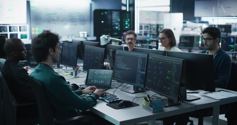 Group of Empowered Multicultural Men and Women Working in a Research Center, Using Computers to Run Advanced Software, Develop Artificial Intelligence Interface and Cyber Security Protocols Royalty-Free Stock Footage #1100036283
